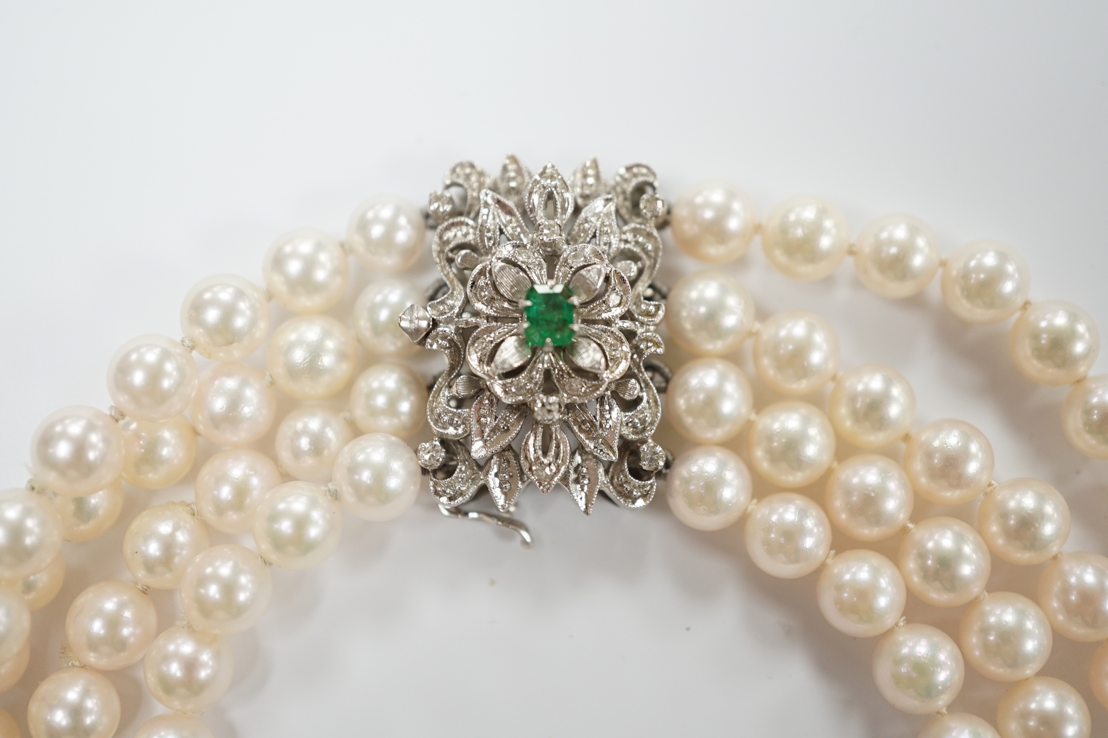A quadruple strand cultured pearl choker necklace, with emerald and diamond chip set 750 white metal clasp, 32cm.